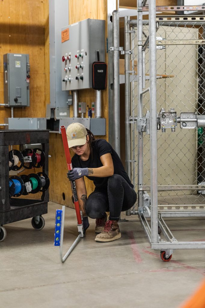 Electrical Apprentice bending conduit.